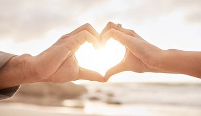 Poster - Couple, hands and heart by sunset with love on beach for honeymoon or vacation in summer with romantic gesture. Commitment, partnership and marriage with trust, promise and together in the Maldives.