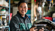 © john - Portrait of smiling mid adult asian mechanic repairing car using digital tablet in workshop
