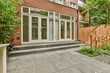 © ADDICTIVE STOCK - Modern home patio with large French doors and garden view
