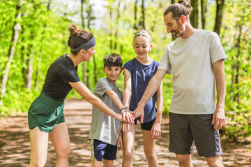 Wall Mural - A Family exercising and jogging together at an outdoor park hand on hand