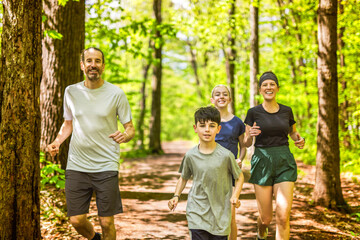 Wall Mural - A Family exercising and jogging together at an outdoor park having great fun