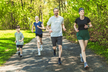 Wall Mural - A Family exercising and jogging together at an outdoor park having great fun