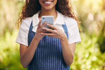 Wall Mural - Young, waitress and phone for typing with smile for social media, joy for news story with online community. Black woman, mobile app and happiness for message with internet, post or like on website