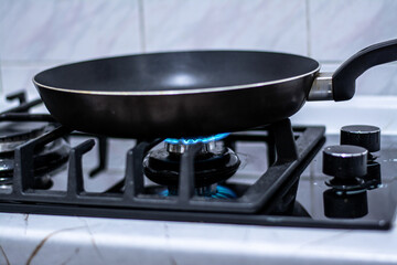 Stainless steel pan on big gas stove burner. High quality photo