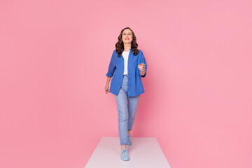 Poster - Full size photo of nice pensioner female walk podium model wear trendy blue outfit isolated on pink color background