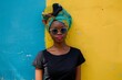 © ylivdesign - Stylish woman in a traditional headscarf poses against a bold yellow wall