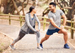 © peopleimages.com - Couple, stretching legs and ready for exercise in outdoor, fitness and preparation for running. People, athletes and warm up for workout in park or nature, flexible and muscle relief for training