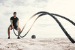 © peopleimages.com - Fitness, with battle rope on beach for endurance challenge, strength or core training in outdoor. Exercise, sports and male athlete for muscle development, intense performance or full body workout