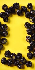 Wall Mural - Fresh blackberry fruits on yellow. Delicious blackberries