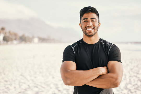 Beach, man and portrait with arms crossed for fitness, exercise and running in morning for physical health. Seaside, male athlete or bodybuilder with pride for cardio, workout or sports by mockup