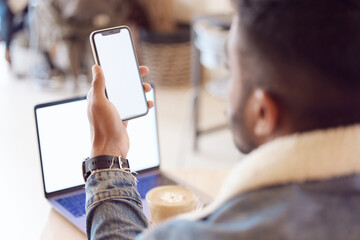 Poster - Man, back and smartphone or laptop screen in coffee shop, mock up and freelancer relax with tech or mobile app. Browse, email and social media or online shopping, male person and blank communication