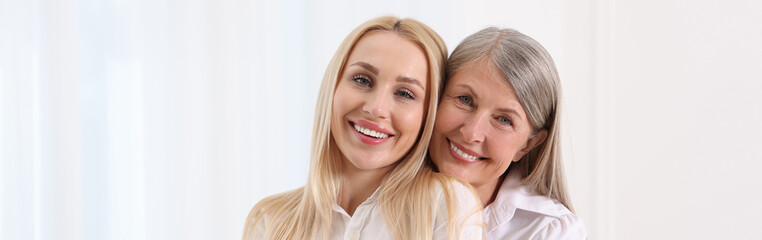 Wall Mural - Happy mother and daughter indoors, banner design