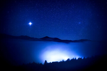Wall Mural - Sky with twinkling stars over mountains at night