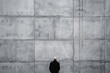 © RealPeopleStudio - An elderly man standing in front of a huge grey wall. Concept of censorship and loneliness