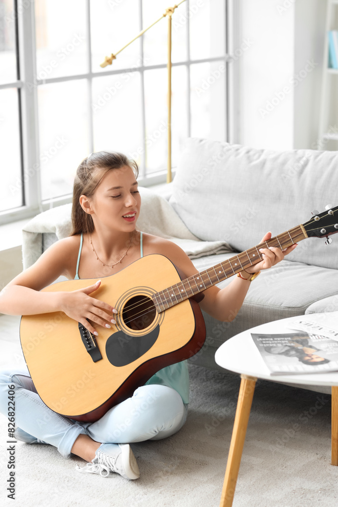 Young woman playing guitar on her day off at home