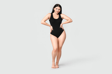 Poster - Body positive young woman on light background