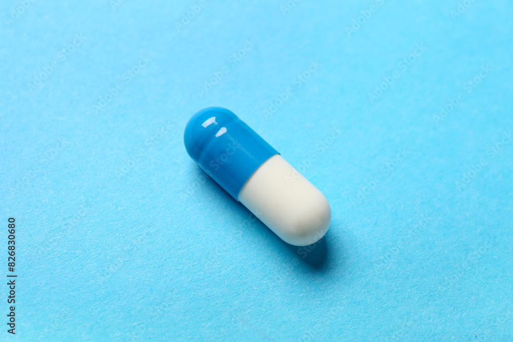 Colorful pill on blue background
