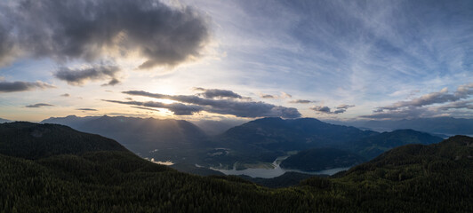 Wall Mural - Dramatic Canadian Mountain Landscape Cloudy Sunset. Aerial Panorama Background.