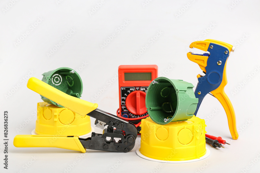 Set of electrician's tools on light background
