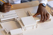 © Wavebreak Media - Young African American male working on architectural model at desk