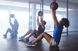 © Wavebreak Media - Three young, fit, diverse men working out with medicine balls at gym