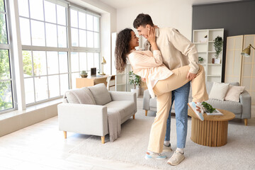 Wall Mural - Young couple in love dancing at home