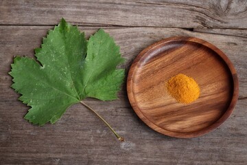 Wall Mural - Turmeric root powder on wood background