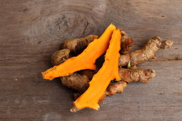 Wall Mural - Turmeric root on wood background