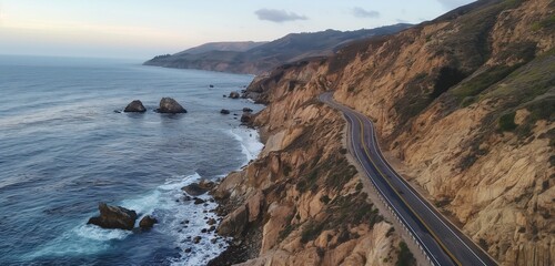 Wall Mural - A drone view of a coastal cliffside road with dramatic drops to the ocean below, and waves crashing against the rocks 32k, full ultra hd, high resolution