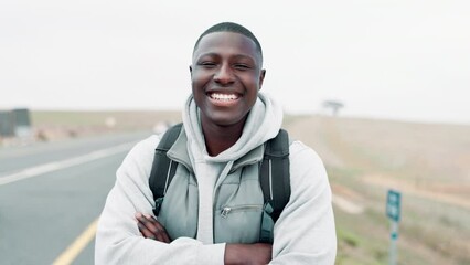 Poster - Smile, arms crossed and face of black man with backpack by road for travel, adventure or holiday. Cars, person and happy at countryside with pride for outdoor trekking, vacation or tourism in Nigeria