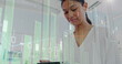 © vectorfusionart - Image of statistical data processing over biracial woman using digital tablet smiling at office