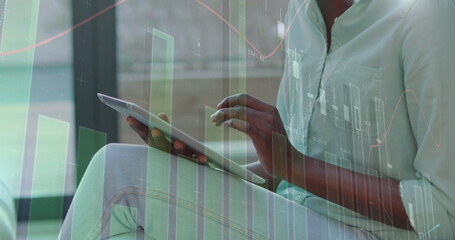 Wall Mural - Image of statistical data processing over african american woman using digital tablet at office