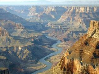 Wall Mural - Spectacular Aerial View of the Grand Canyon with Colorado River Winding Through Majestic Rocky Landscape under Clear Skies