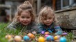 © Tanayut - Joyful Siblings on an Easter Egg Hunt in the Garden, Smiling and Having Fun Together