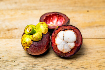 Mangosteen fruit isolated on wooden background. Mangosteen is known as a fruit that has very high levels of antioxidants. Garcinia mangostana