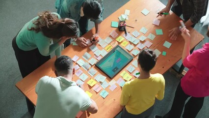 Wall Mural - Top view of skilled programmer brainstorming idea about mobile phone interface while develop app development by using wireframe prototype. Web designer planning at table with sticky notes. Symposium.