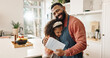 © peopleimages.com - Kitchen, father and girl with card, hug and gift for fathers day, love and care in family and house. Home, dad and daughter with embrace, happiness and cute in apartment, man or child with present