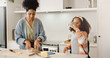 © peopleimages.com - Mother, child and packing sandwich for school lunch or preparing in home kitchen, morning or student. Woman, daughter and breakfast drink in apartment or nutrition meal for education, snack or health