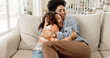 © peopleimages.com - Happy, family hug and mother on sofa at home with smile, living room and bonding together with love. Care, joke and lounge with child and relax with couch and laughing from new house with fun