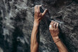 © Cavan Images - Close-up of climber's hands on rugged rock surface