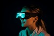 © alisaaa - Young woman scientist is wearing futuristic VR glasses and looking down at night
