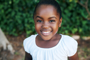 Relax, smile and portrait of black child in garden for outdoor adventure, weekend and summer vacation. Kid, little girl and joyful in nature park for break, happiness and holiday fun in Nigeria