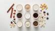 © Ron - Top view of various types of milk and ingredients on a white background, in a flat lay. On the left side are ceylon cinnamon sticks, cardamom seeds, and vanilla beans.