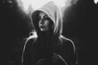 © alisaaa - Young woman in hooded top listening to music