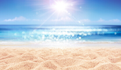 beach and sea - summer vacation on sunny sand with glittering on defocused ocean - focus in foregrou
