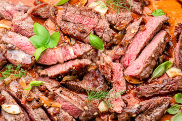 Poster - Sliced juicy medium rib eye steak on wooden board. Top view.