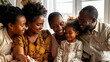 © BetterPhoto - A family of four, including a young girl, are sitting together and smiling