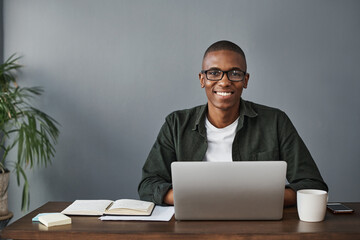 Fototapete - Business, laptop and portrait of happy black man in office for software, research and information in creative startup. Face, computer and web developer in glasses or African entrepreneur in Kenya