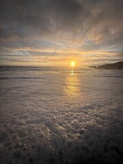 Wall Mural - Scenic beach at dusk with a dramatic sky