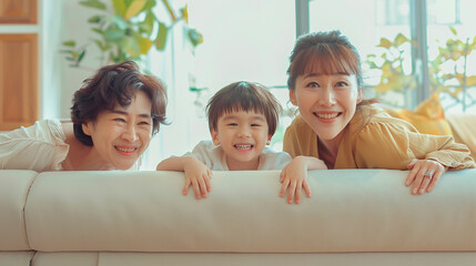Wall Mural - A family of three, a woman and two children, are sitting on a couch and smiling